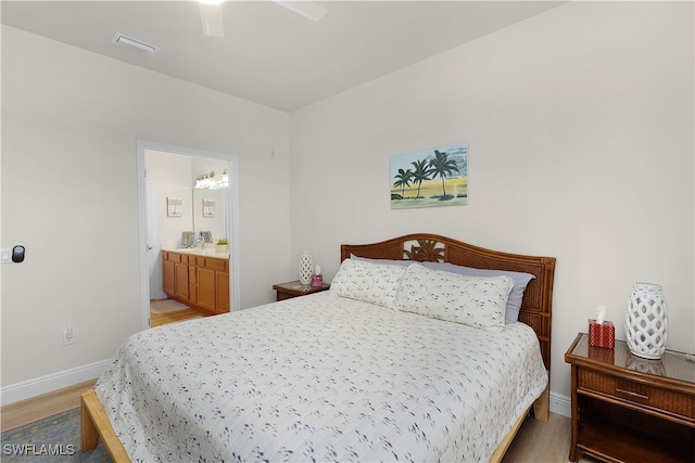 bedroom featuring ensuite bath, ceiling fan, and light hardwood / wood-style flooring