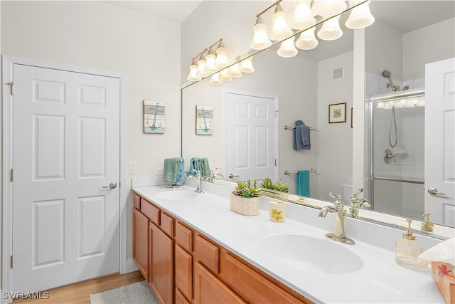 bathroom featuring wood-type flooring, vanity, and walk in shower