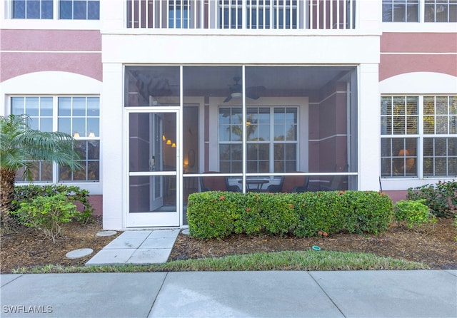 entrance to property featuring ceiling fan