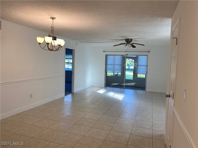 unfurnished room featuring a textured ceiling, light tile patterned floors, and ceiling fan with notable chandelier