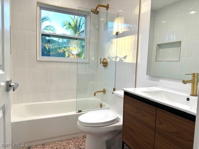 full bathroom with vanity, toilet, and tiled shower / bath