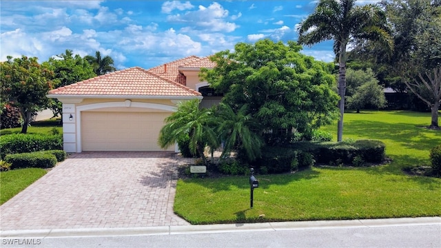 view of front of house featuring stucco siding, a front lawn, a tile roof, decorative driveway, and an attached garage