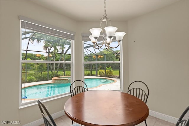 dining space featuring light tile patterned floors, an inviting chandelier, and baseboards