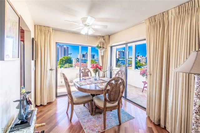 dining area with hardwood / wood-style flooring and ceiling fan