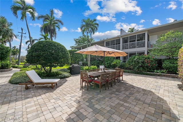 view of patio / terrace with a sunroom and grilling area