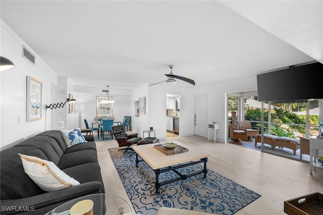 living room featuring light wood-type flooring and ceiling fan