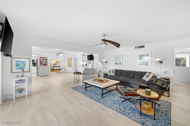 living room featuring ceiling fan and light hardwood / wood-style floors