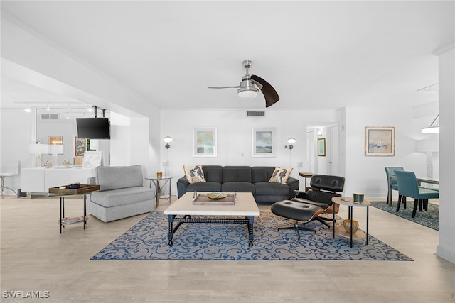 living room featuring ceiling fan, light wood-type flooring, ornamental molding, and track lighting