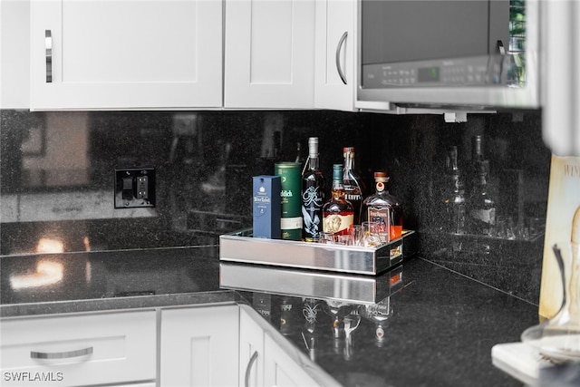 kitchen featuring white cabinets and decorative backsplash