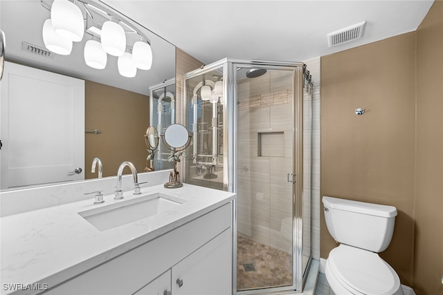 bathroom with tile patterned flooring, vanity, toilet, and walk in shower