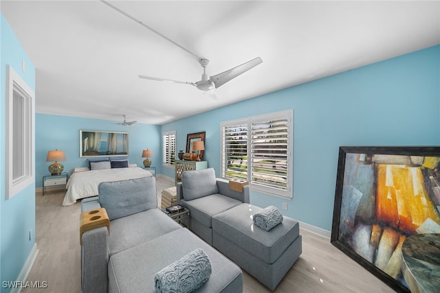 bedroom with light hardwood / wood-style flooring and ceiling fan