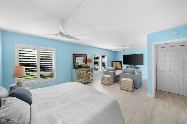 bedroom featuring a closet, ceiling fan, and light hardwood / wood-style flooring