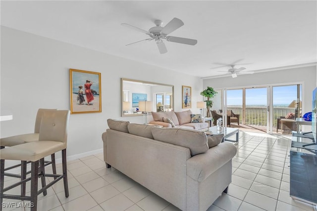 13105 Vanderbilt Dr Unit 802, Naples, FL 34110 - living room featuring light tile patterned floors, a ceiling fan, and baseboards
