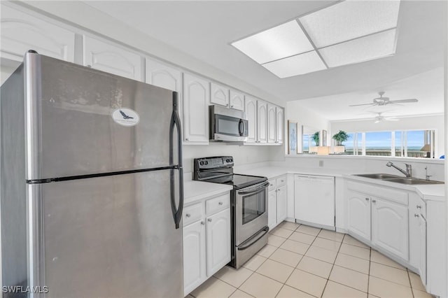 kitchen with light tile patterned floors, white cabinetry, ceiling fan, stainless steel appliances, and sink