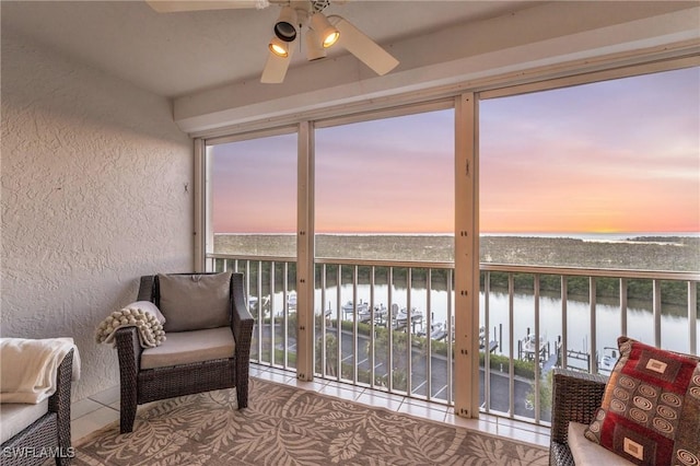 13105 Vanderbilt Dr Unit 802, Naples, FL 34110 - sunroom / solarium with a water view, a textured wall, and tile patterned floors