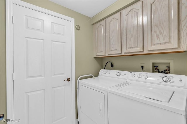 laundry room featuring cabinets and washer and clothes dryer