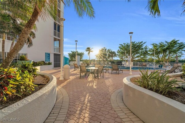 13105 Vanderbilt Dr Unit 802, Naples, FL 34110 - view of patio / terrace with a community pool
