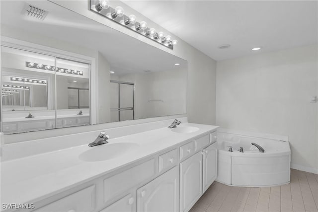 bathroom with tile patterned floors, separate shower and tub, and vanity