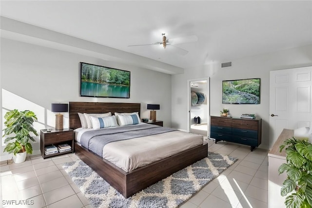 bedroom featuring ceiling fan, connected bathroom, and light tile patterned floors