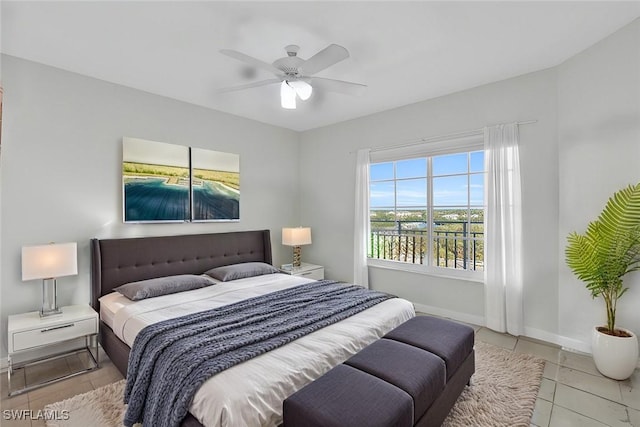 bedroom with ceiling fan, light tile patterned flooring, and multiple windows