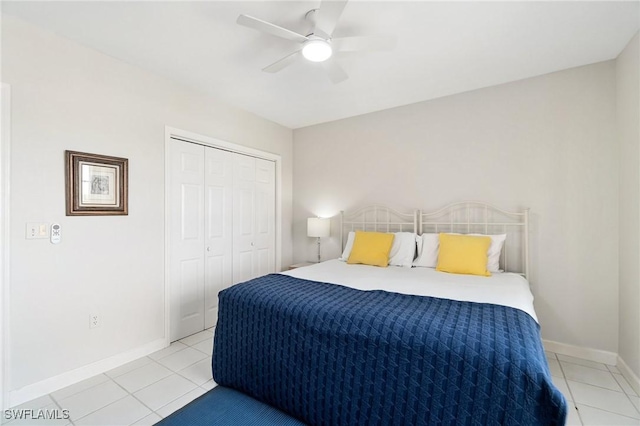 13105 Vanderbilt Dr Unit 802, Naples, FL 34110 - bedroom with light tile patterned flooring, baseboards, a closet, and ceiling fan