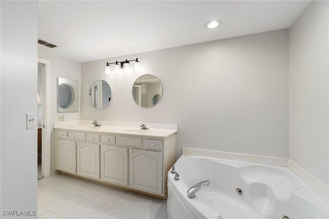 13105 Vanderbilt Dr Unit 802, Naples, FL 34110 - bathroom with a jetted tub, double vanity, tile patterned floors, and recessed lighting