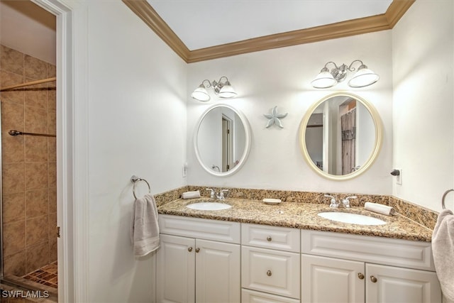 bathroom with a tile shower, crown molding, and vanity