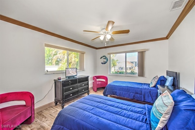 bedroom featuring ceiling fan, ornamental molding, and light hardwood / wood-style flooring