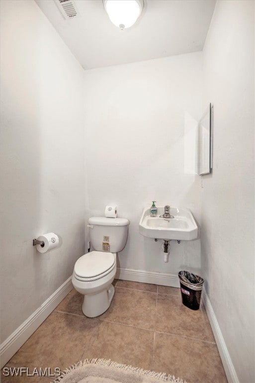 bathroom featuring sink, tile patterned flooring, and toilet