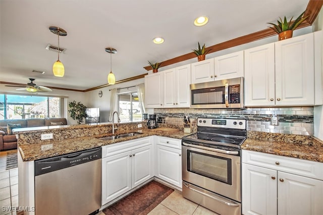 kitchen with white cabinetry, a healthy amount of sunlight, and appliances with stainless steel finishes