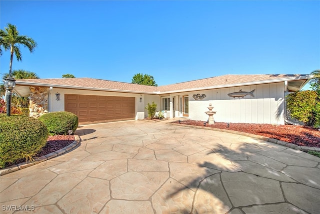 ranch-style home featuring a garage