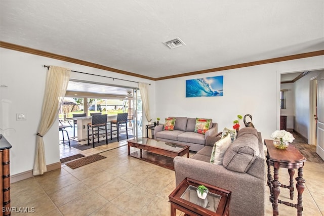 living room with ornamental molding and light tile patterned floors