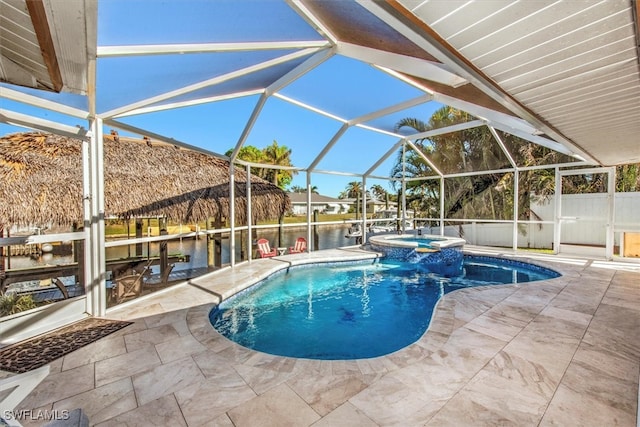 view of swimming pool featuring a lanai, a patio area, an in ground hot tub, and a water view