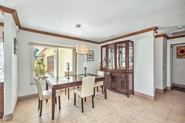 dining space with light tile patterned floors and crown molding