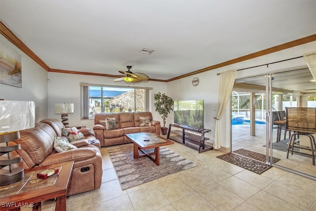 living room with light tile patterned floors, ceiling fan, and crown molding