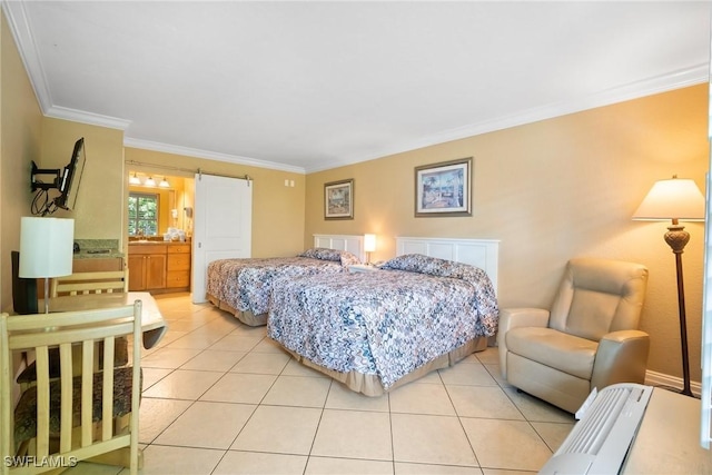 bedroom with light tile patterned floors, ensuite bathroom, a barn door, and ornamental molding