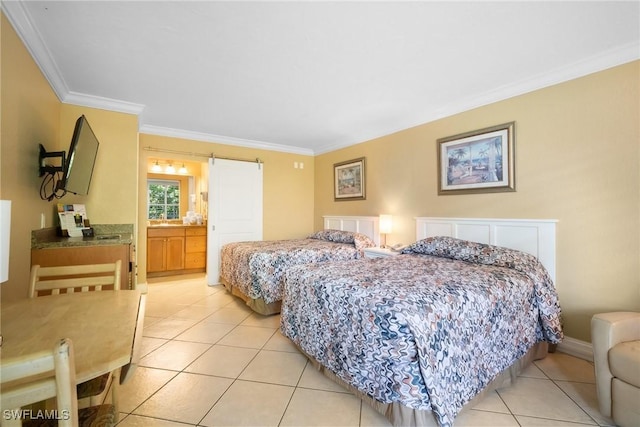 bedroom with light tile patterned floors, a barn door, baseboards, and crown molding