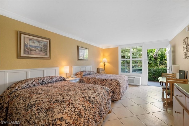 bedroom featuring a decorative wall, light tile patterned floors, a wall mounted air conditioner, and ornamental molding