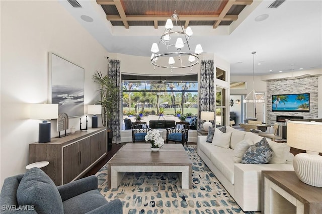 living room with coffered ceiling, a fireplace, beam ceiling, wood-type flooring, and a chandelier