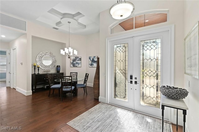 foyer featuring french doors, ceiling fan with notable chandelier, and dark hardwood / wood-style floors