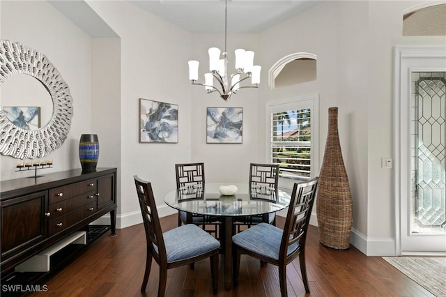 dining area with a chandelier and dark hardwood / wood-style flooring