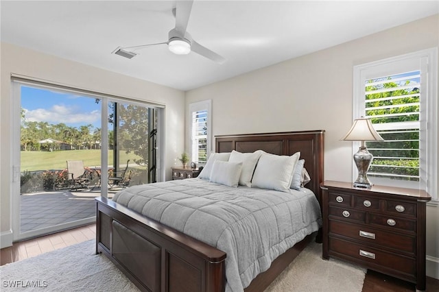 bedroom with access to exterior, light hardwood / wood-style floors, and ceiling fan