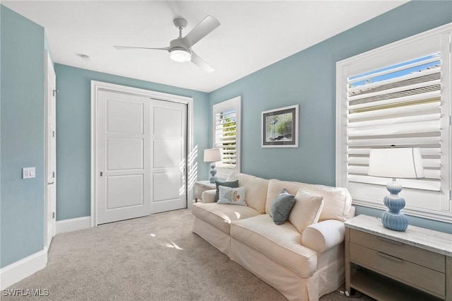 sitting room with light colored carpet and ceiling fan