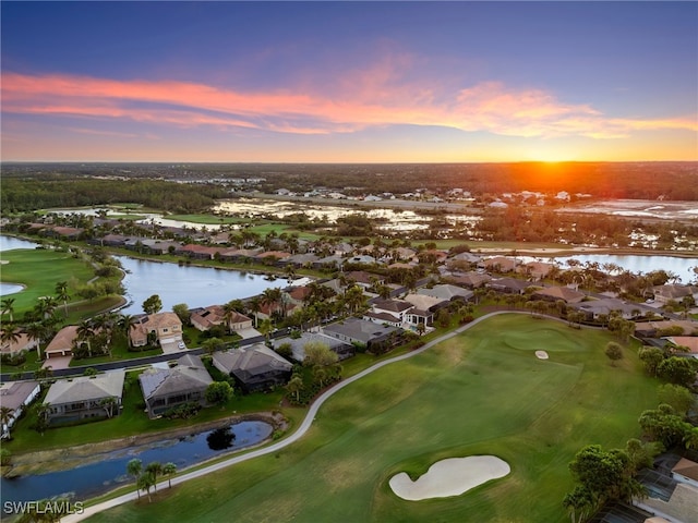 aerial view at dusk with a water view