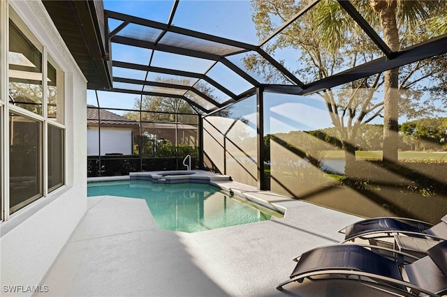 view of pool with a lanai and a patio