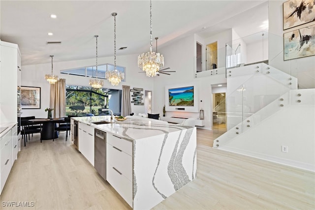 kitchen featuring white cabinets, a large island, pendant lighting, and high vaulted ceiling