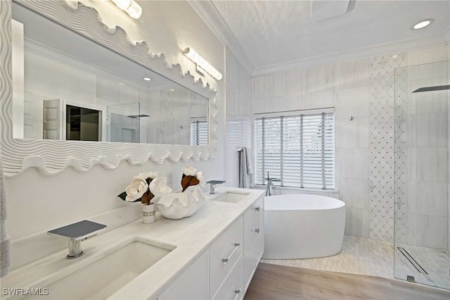 bathroom with wood-type flooring, vanity, independent shower and bath, and crown molding