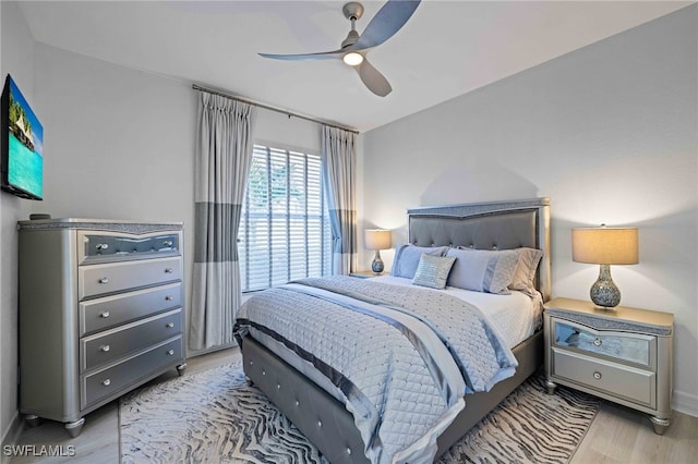 bedroom with ceiling fan and light hardwood / wood-style floors