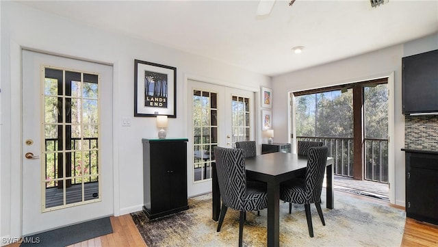 dining room with french doors and wood-type flooring