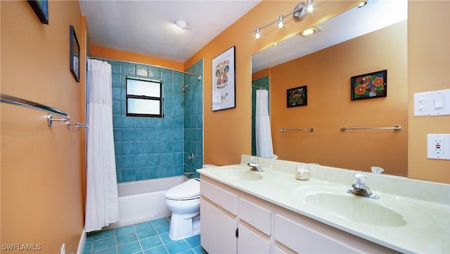 full bathroom with tile patterned flooring, shower / tub combo with curtain, vanity, and toilet